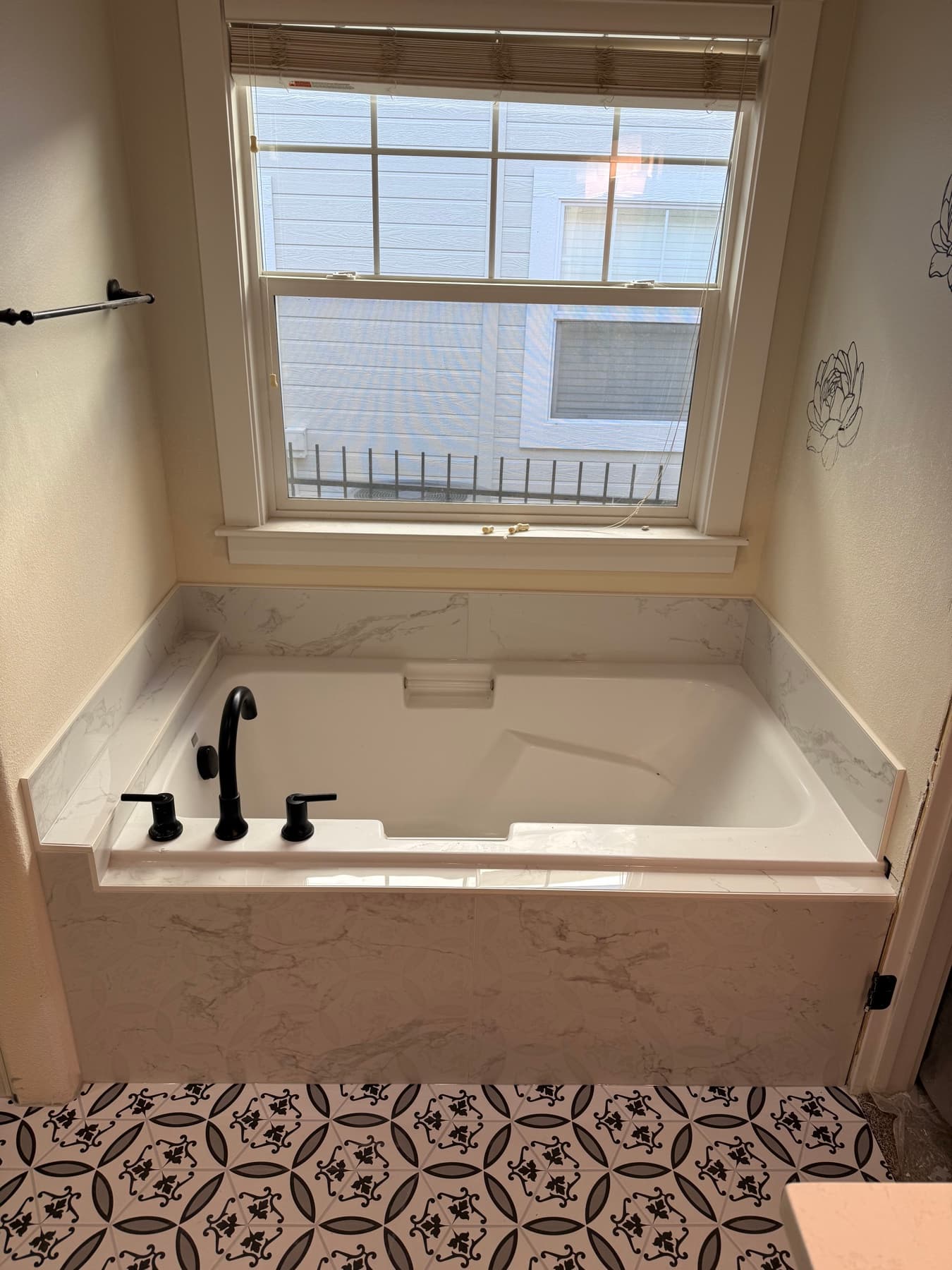 Bathroom tile remodel with patterned accent wall and tub