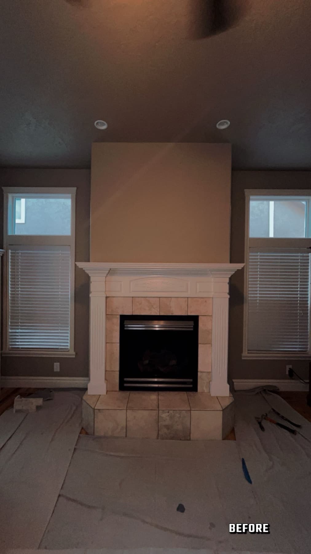 Floor-to-ceiling stacked stone fireplace surround