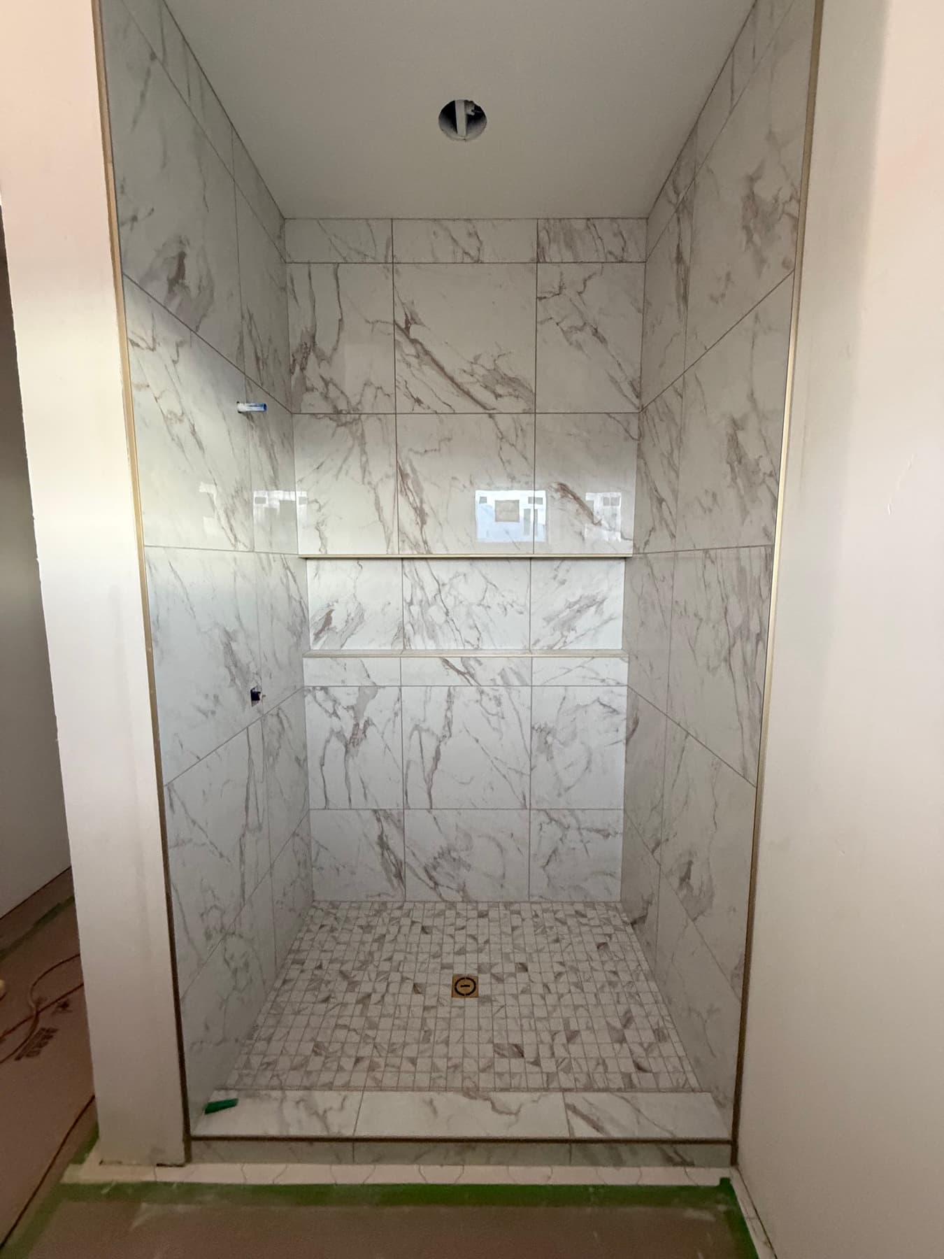 Clean marble shower walls with large-format tile