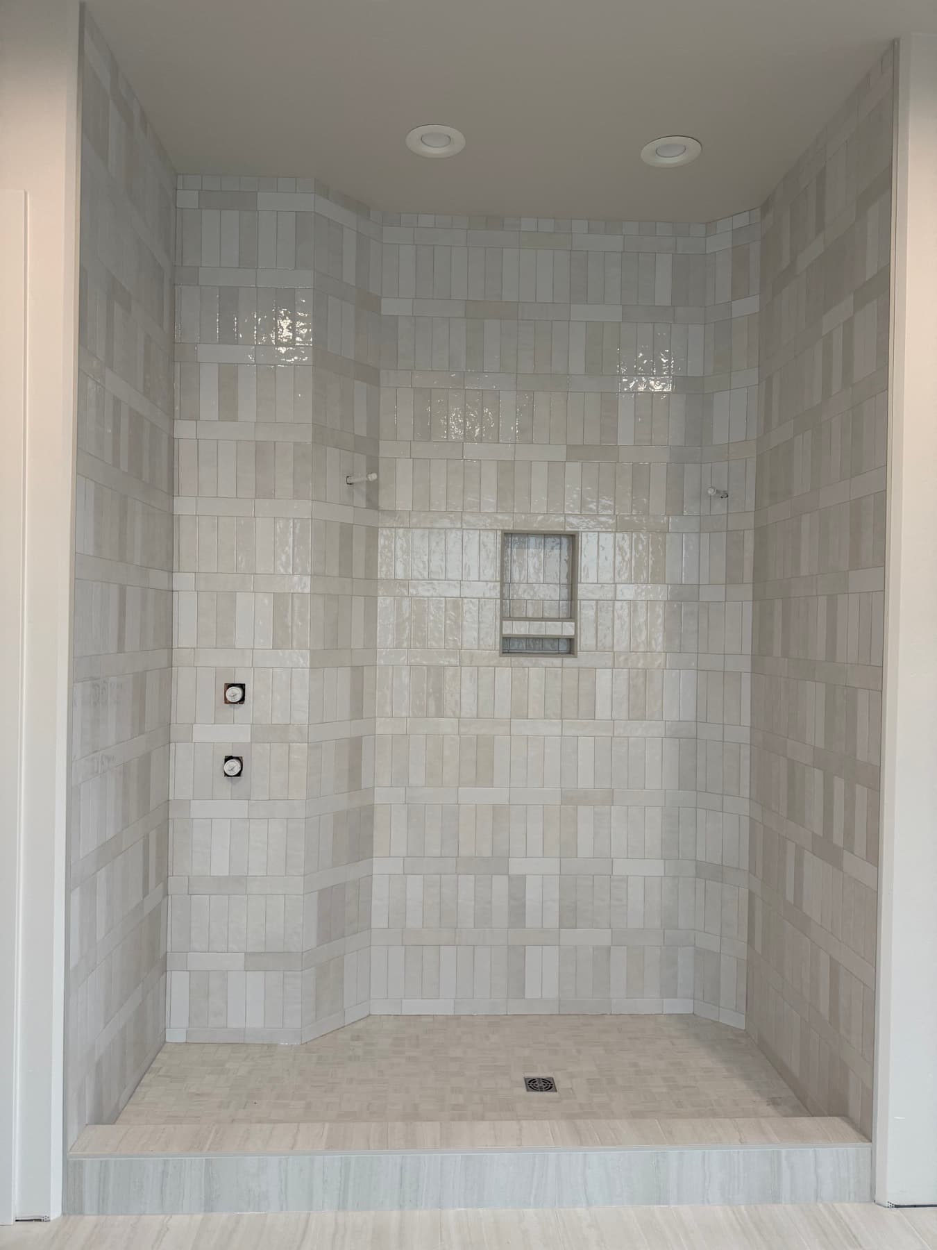 Custom marble walk-in shower with large-format tile